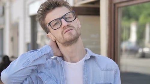 Man Experiences Neck Pain Outside