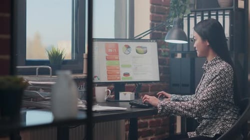 Woman Typing at Computer in Modern Office Setting