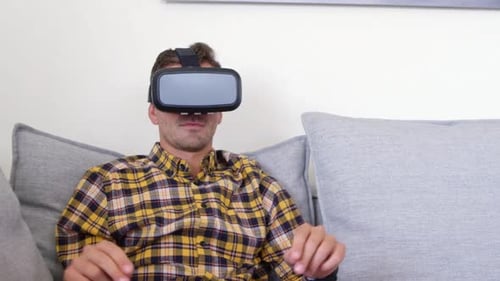 Man Using Virtual Reality Headset on Couch