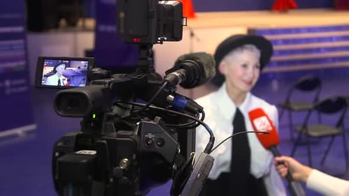 Television Camera Broadcast Interview with Business Woman Speaker in Conference Hall Room Spbd