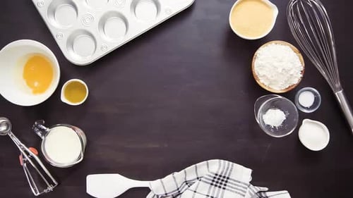 Time lapse. Step by step. Buttering metal cupcake pan to bake cornbread muffins.