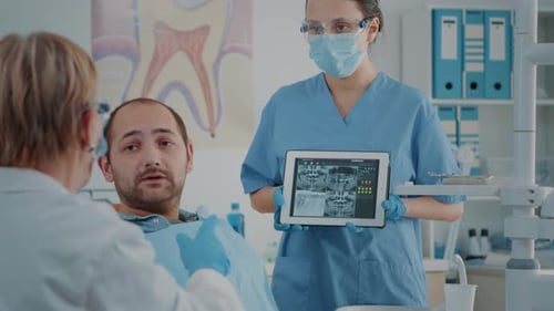 Medical Professionals Consulting with Patient in Office
