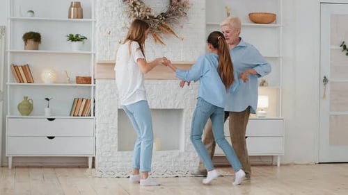 Three Generations Dancing Together Happily at Home