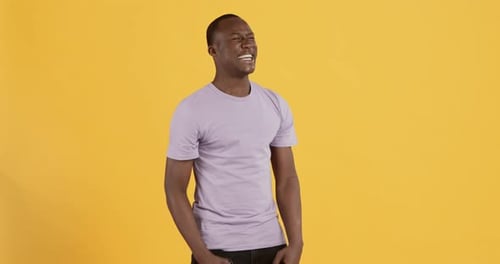 Man Dancing Happily Against Yellow Background