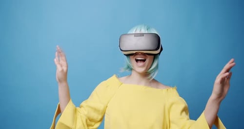 Woman wearing VR headset against blue background