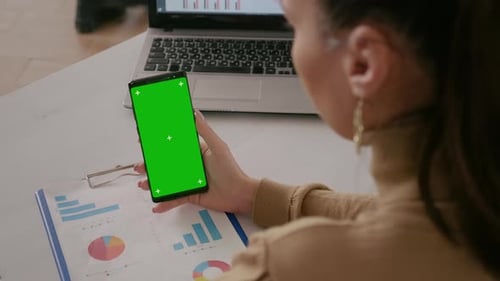 Close Up of Woman Looking at Telephone with Green Screen