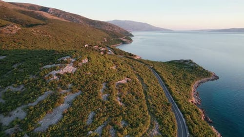 Aerial View Landscape Rocky Coast of Croatia with Curvy Mountain Road at Sunset