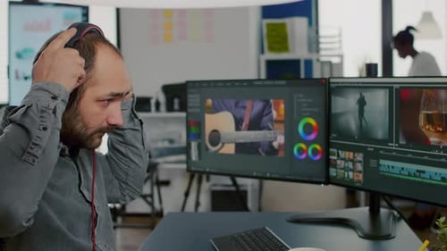Man Editing Video at Computer Workstation