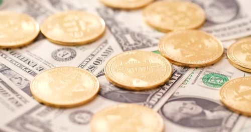 Bitcoins Scattered on US Dollar Bills
