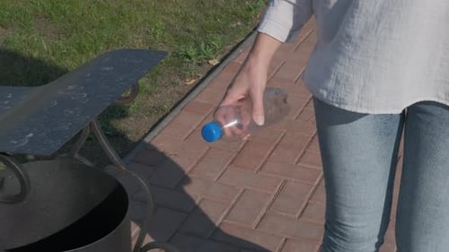 Throw plastic into a trash.