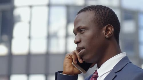 Self Confident Business Man Talking by Phone in The Street