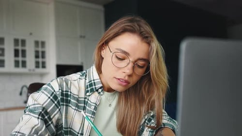 Woman Working on Laptop at Home Office