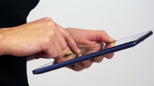A Woman Works on a Tablet - Closeup - White Screen Studio