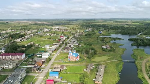 Aerial view of Church in the village. Near the river and bridge