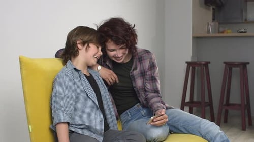 Woman and Child Using Phone Together Indoors