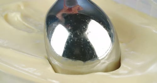 Macro slow motion of mango sorbet ice cream with scoop