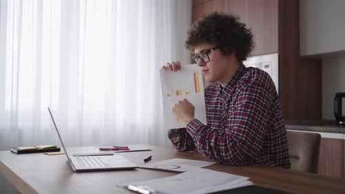 Young Adult Presenting Data on Video Call