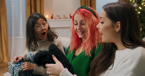 Friends Opening Gifts During Christmas Celebration