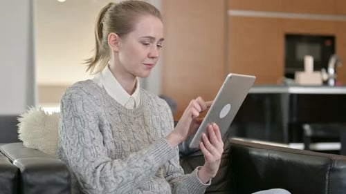 Woman Using Tablet Device in Modern Living Room