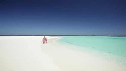 Loving Couple Walking Towards Camera on Sandy Beach