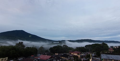 Mountains and Fog Over Small Town Landscape