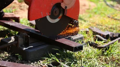 Worker cutting metal and spark with cutting machine