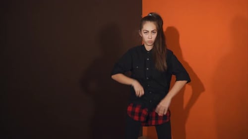 An Adult Girl Trains in the Performance of Hip Hop Dance in the Original Studio