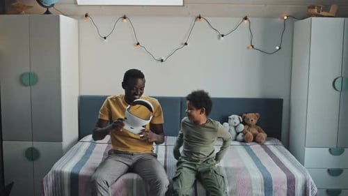 Father and Son Playing With VR Headset at Home