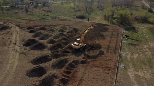 Excavator Levels Ground on Construction Site Aerial View