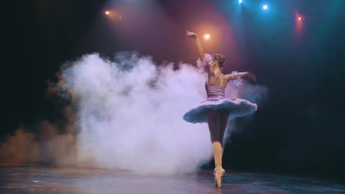 Ballerina Dancing Elegantly on Stage in the Night