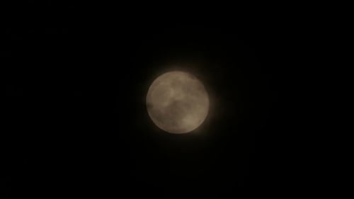 Full Moon in Night Sky with Passing Clouds