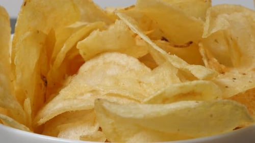 Close Up of Golden Potato Chips in Bowl