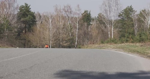 Cyclist rides uphill on bike. Woman cycling. Cycling in mountains. Girl riding on a road bike