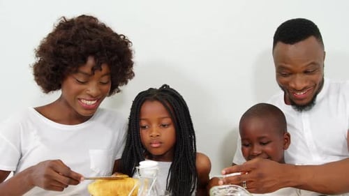 Happy Family Eating Breakfast Together at Home