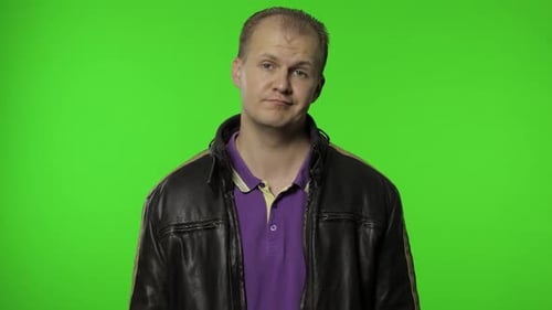 Man in Leather Jacket Talking in Front of Greenscreen