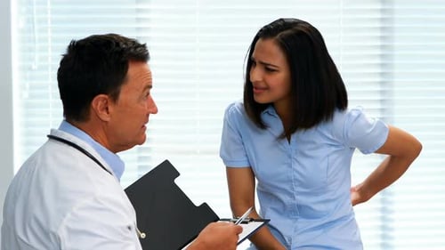 Doctor Talking With Patient About Back Pain