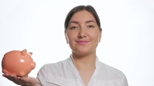Calm Dark Haired Woman Holds Small Pink Piggy Bank on Palm