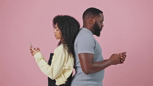 Young Friends Using Phones and Laughing Together