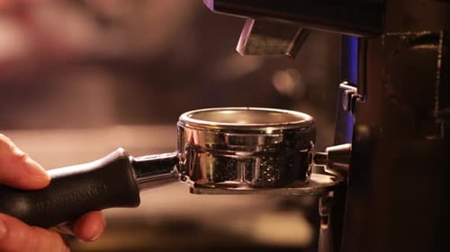 Hand Placing Portafilter for Coffee Grinding