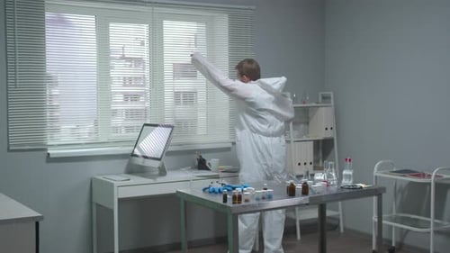 Scientist Putting on Hazmat Suit in Lab