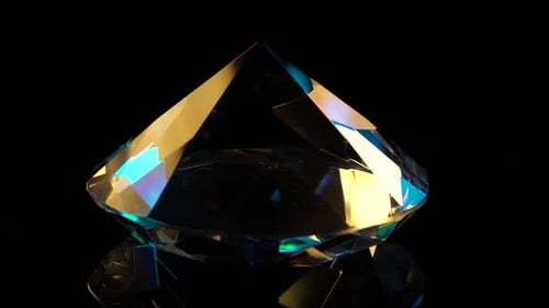 Diamond Slowly Rotates with a Sharp End Up. Black Background