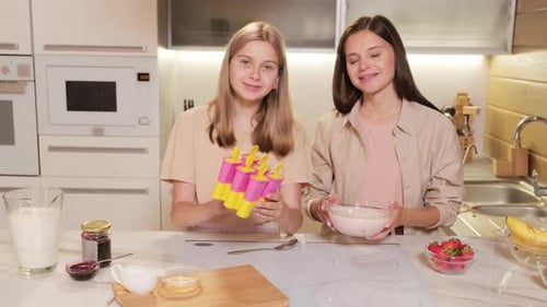 Pouring Popsicle Mixture To Plastic Moulds
