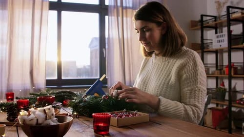 Woman Crafts Festive Wreath at Home