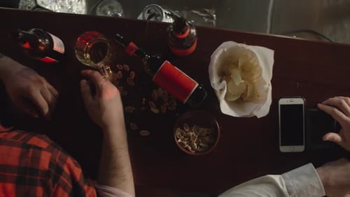 Man Pays for Drinks at Bar with Friend