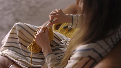 Close Up Woman Hands Crocheting with Knitting Needles a Handbag at Home, Copy Space, Hobby Concept