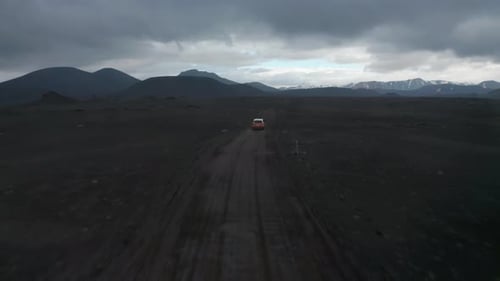 Forwards Tracking of Car on Dirt Road in Barren Countryside