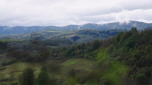 green mountains with cloudy sky