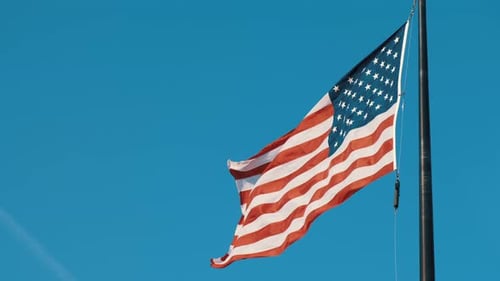 American Flag Waving Against a Blue Sky