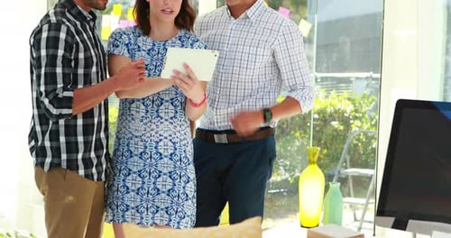 Team Collaborating on Tablet in Modern Office