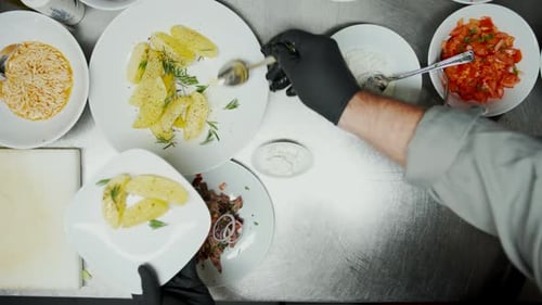 Plating Potatoes and Noodles in a Kitchen
